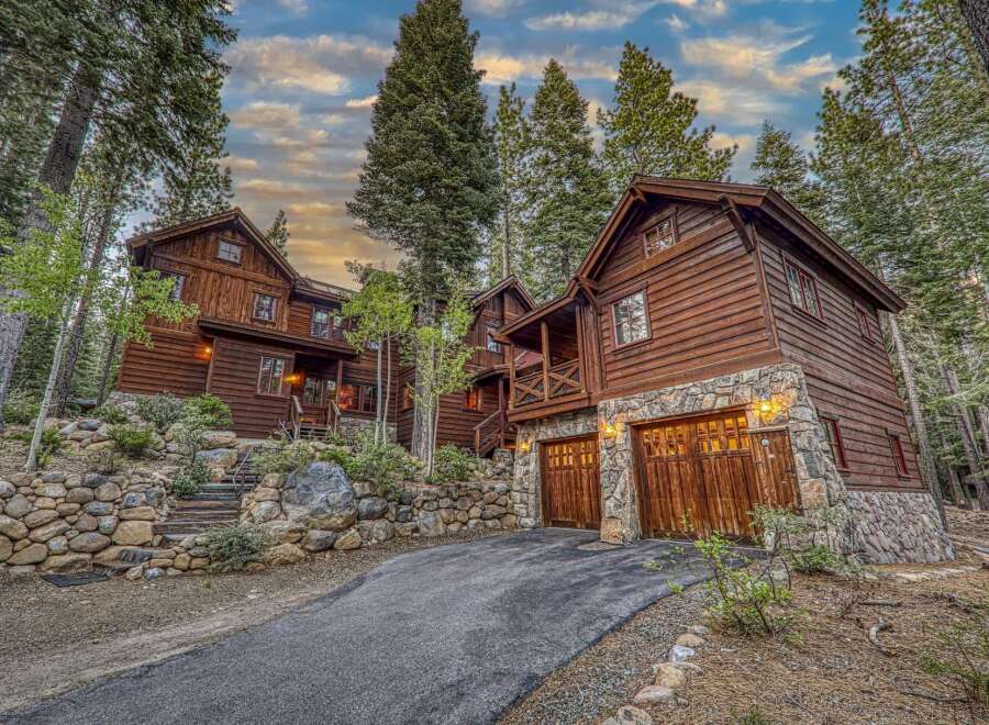 Nestled amidst towering trees, this stunning wooden cabin offers a serene escape.
