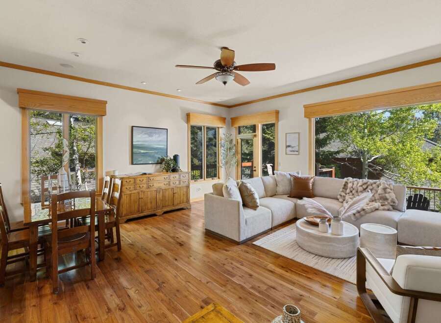 Step into luxury with this stunning property, featuring a spacious living area with a cozy sectional sofa and a beautiful view.