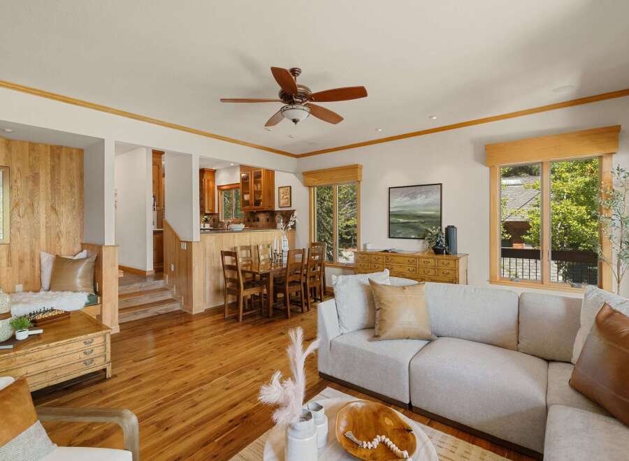 Step into this inviting home featuring a spacious living area with hardwood floors and a cozy fireplace.