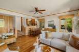 Step into this inviting home featuring a spacious living area with hardwood floors and a cozy fireplace.