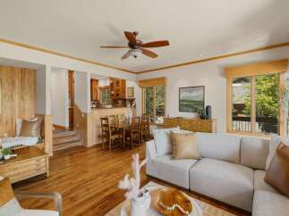 Step into this inviting home featuring a spacious living area with hardwood floors and a cozy fireplace.