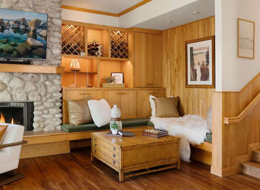 This stunning property boasts a cozy living space with a stone fireplace and a built-in wine rack, perfect for entertaining.