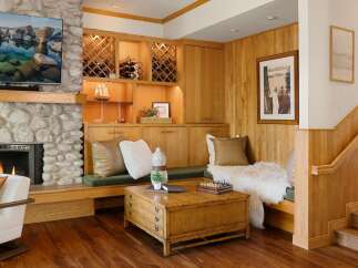 This stunning property boasts a cozy living space with a stone fireplace and a built-in wine rack, perfect for entertaining.