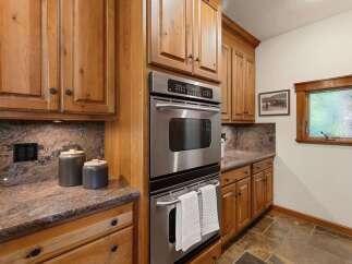 This stunning kitchen boasts custom cabinetry and high-end stainless steel appliances.