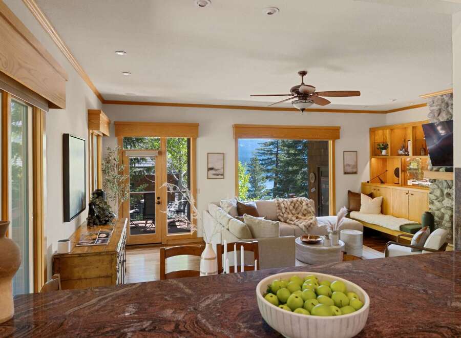 Experience luxury living in this stunning property, featuring a bright and airy living room with large windows that offer breathtaking views.