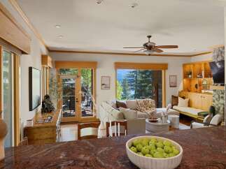Experience luxury living in this stunning property, featuring a bright and airy living room with large windows that offer breathtaking views.
