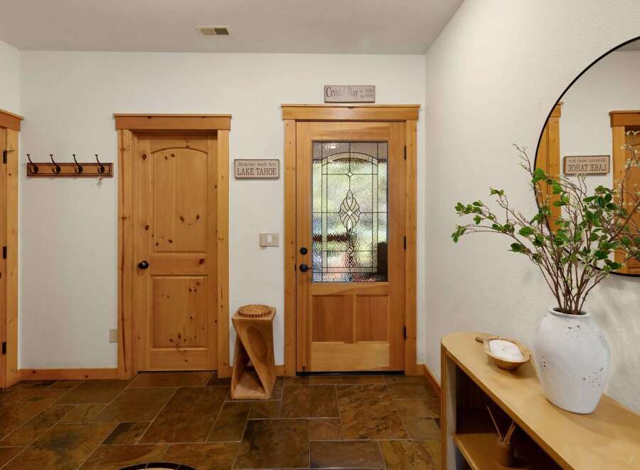 Step into this inviting entryway, showcasing a blend of rustic charm and modern design.