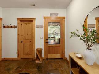 Step into this inviting entryway, showcasing a blend of rustic charm and modern design.