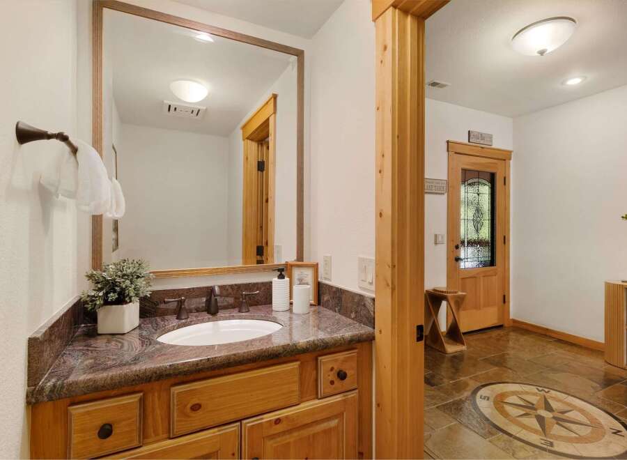 Step into luxury with this stunning bathroom featuring a beautiful vanity and a large mirror.