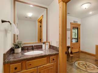 Step into luxury with this stunning bathroom featuring a beautiful vanity and a large mirror.