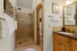Step into a beautifully designed bathroom featuring a spacious glass shower and elegant wooden accents.