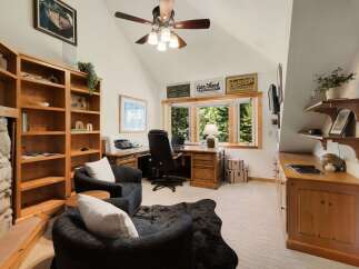 This stunning home office boasts a cozy and inviting atmosphere, perfect for productivity and relaxation.