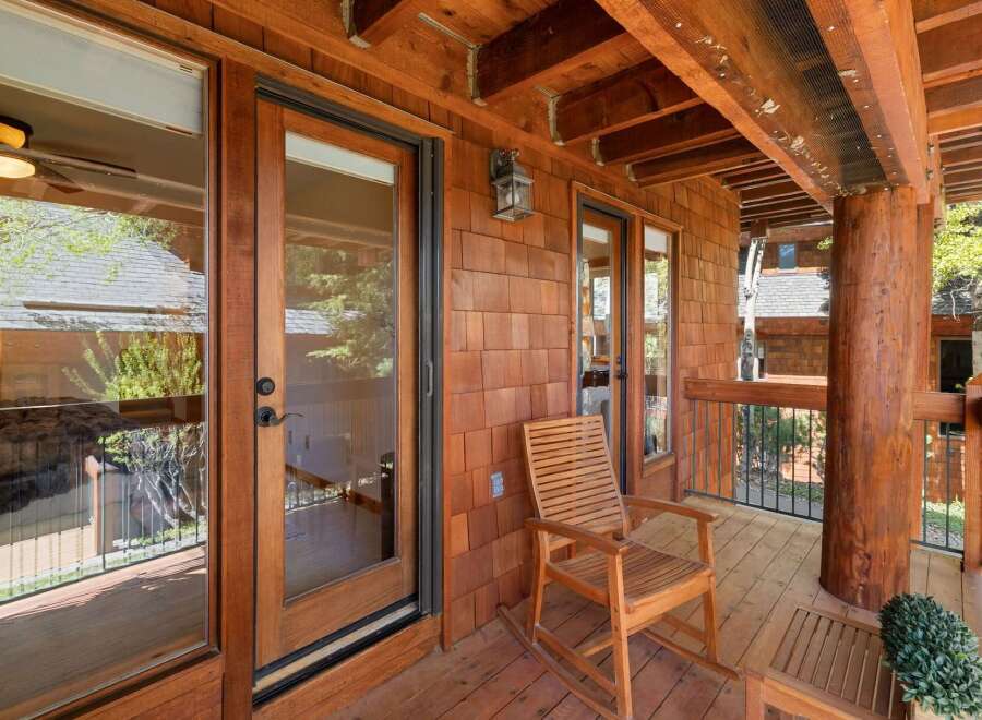 Enjoy the tranquility of this stunning wooden porch, perfect for relaxing and taking in the natural surroundings.