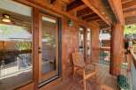 Enjoy the tranquility of this stunning wooden porch, perfect for relaxing and taking in the natural surroundings.