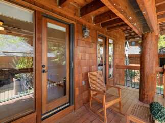 Enjoy the tranquility of this stunning wooden porch, perfect for relaxing and taking in the natural surroundings.