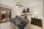 This stunning bedroom boasts a cozy ambiance with its plush, faux fur blanket and inviting decor.