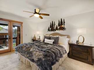 This stunning bedroom boasts a cozy ambiance with its plush, faux fur blanket and inviting decor.