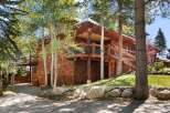 Nestled amidst lush greenery, this stunning property boasts a unique architectural design with cedar siding and multiple levels.