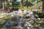 Discover a serene oasis in this stunning property, featuring a beautifully designed rock waterfall.