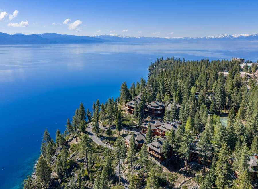 Nestled on a stunning cliffside, this property offers breathtaking views of the serene lake and surrounding mountains.