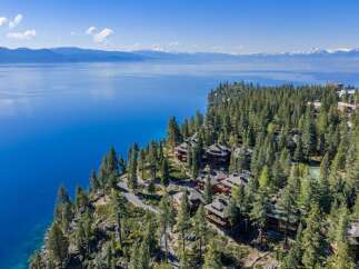Nestled on a stunning cliffside, this property offers breathtaking views of the serene lake and surrounding mountains.
