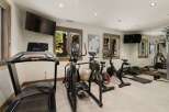 This home gym offers a comprehensive workout experience with a variety of equipment.