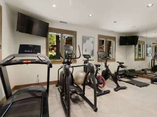 This home gym offers a comprehensive workout experience with a variety of equipment.