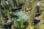 Nestled amidst a lush forest, this property boasts a private tennis court, perfect for active living and outdoor recreation.