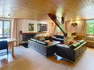 Step into this charming living space, featuring a cozy fireplace and a modern TV setup, perfect for relaxing evenings.