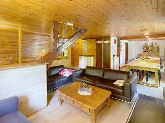 This charming property boasts a warm and inviting interior with wooden accents throughout.