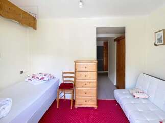 Discover this charming property featuring a cozy bedroom with a comfortable bed and a stylish white sofa.