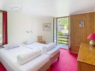 This charming property features a cozy bedroom with two comfortable beds, perfect for a relaxing stay.