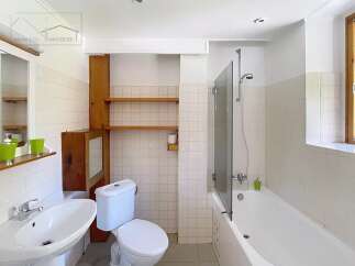 Discover this charming bathroom featuring a bright and airy design.