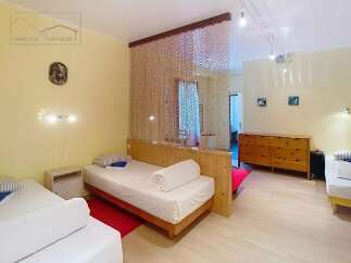 Discover this charming property featuring a cozy bedroom with comfortable beds and a stylish wooden partition.