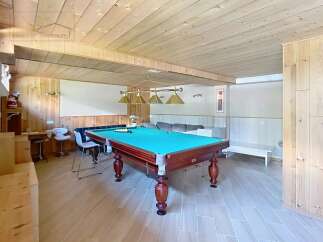 This stunning property boasts a spacious game room, perfect for entertaining guests.