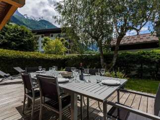 Enjoy outdoor dining in this stunning property with a spacious deck and breathtaking mountain views.