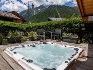 Relax and unwind in this luxurious property featuring a private hot tub, perfect for enjoying the stunning mountain views.