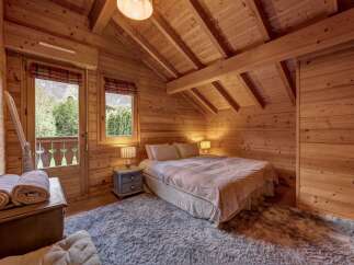 Step into this charming bedroom, where rustic elegance meets modern comfort.