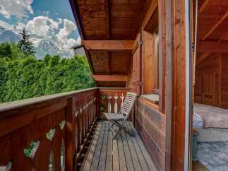 Enjoy breathtaking mountain views from this charming balcony.