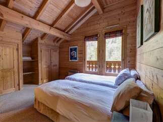 This cozy bedroom features a rustic wooden design, creating a warm and inviting atmosphere.