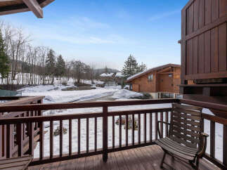 Enjoy breathtaking views from this charming balcony overlooking a winter wonderland.