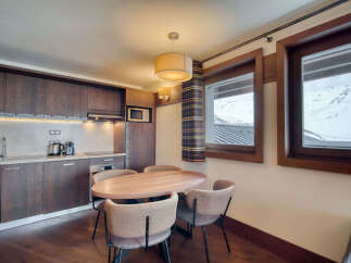 This charming kitchen and dining area offers a cozy space for meals and gatherings.
