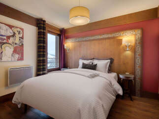 Experience the charm of this cozy bedroom, featuring a comfortable bed and elegant decor.