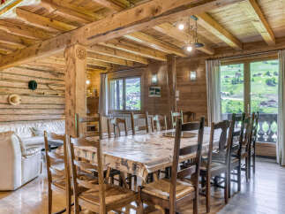 Step into rustic elegance with this stunning property, featuring a spacious dining area perfect for gatherings.