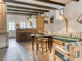 Step into this charming property featuring a rustic interior with exposed wooden beams and a cozy atmosphere.