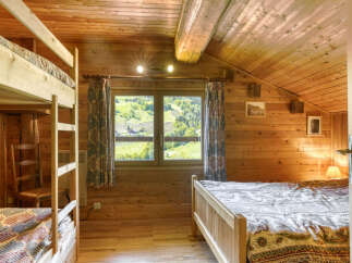 This cozy cabin features a warm, inviting interior with wooden walls and ceilings.