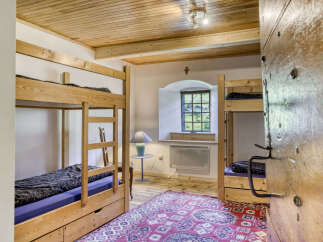 This charming room features two sets of bunk beds, perfect for accommodating multiple guests or family members.