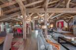 Experience luxury living in this stunning chalet, showcasing exposed wooden beams and a spacious open floor plan.