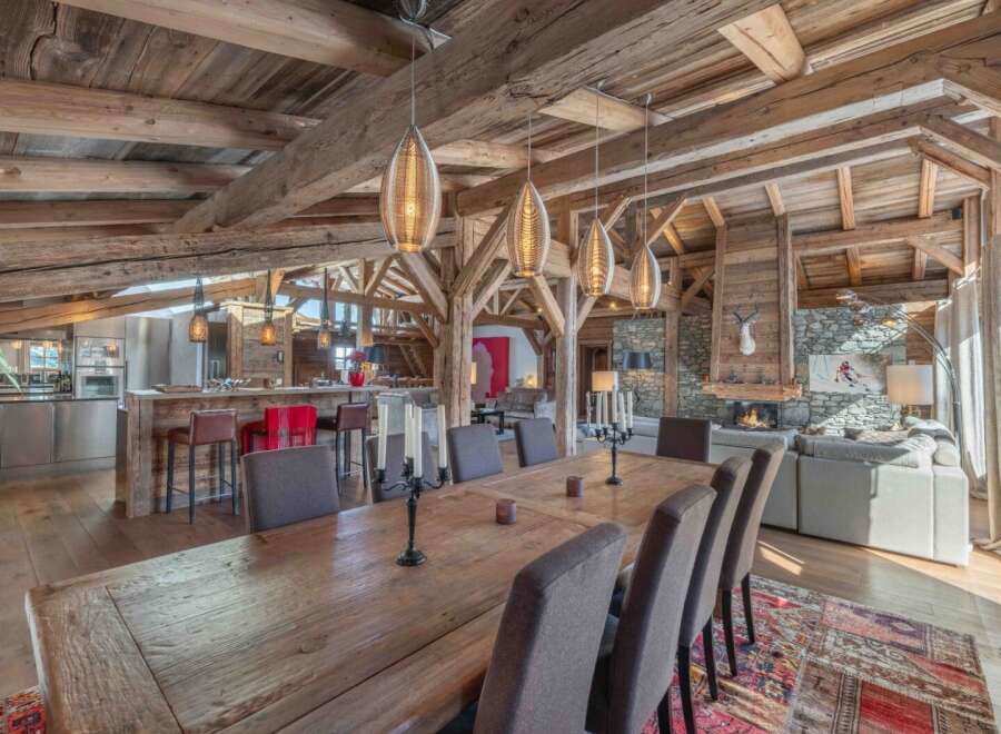 Experience luxury living in this stunning chalet, showcasing exquisite wooden beams and a cozy fireplace.