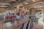 Experience luxury living in this stunning chalet, showcasing exquisite wooden beams and a cozy fireplace.